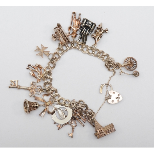 157 - A silver heart shaped clasped charm bracelet with charms, 47gm.