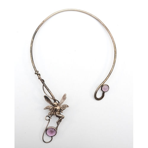 168 - An unmarked silver fairy torque necklace with pink glass set stones 13.2 x 22cm, 54gm.