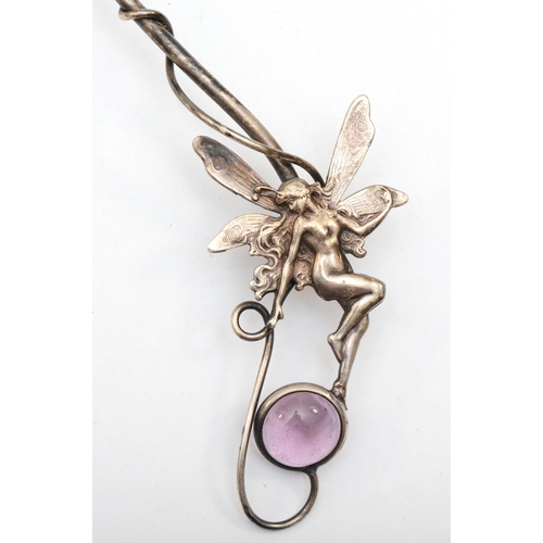 168 - An unmarked silver fairy torque necklace with pink glass set stones 13.2 x 22cm, 54gm.