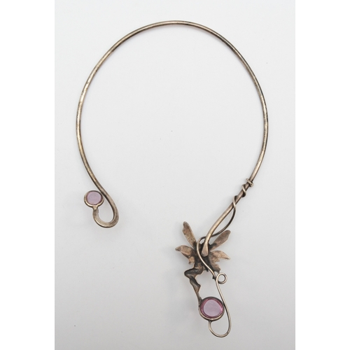 168 - An unmarked silver fairy torque necklace with pink glass set stones 13.2 x 22cm, 54gm.