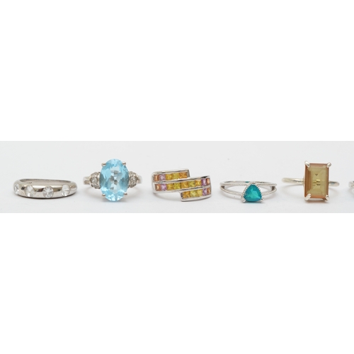 172 - A group of eight silver gem set rings to include a topaz dress ring, L-M, 28gm.