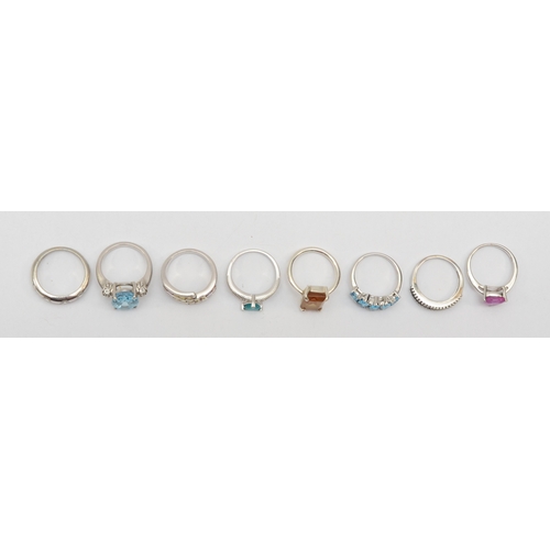 172 - A group of eight silver gem set rings to include a topaz dress ring, L-M, 28gm.