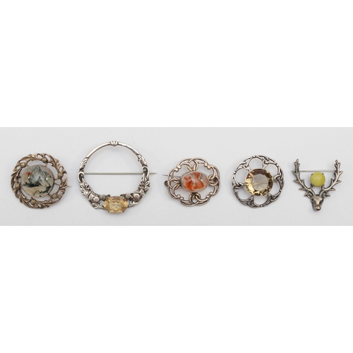 173 - A group of five Scottish silver brooches to include a Robert Allison citrine and thistle brooch, Gla... 