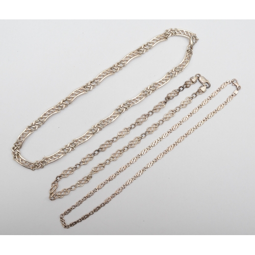 176 - A silver segmented chain, 47cm, together with two other fancy link chains, 66gm.