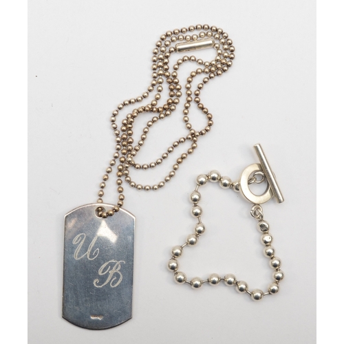 179 - Gucci, a silver dog tag pendant on a beaded chain 49 x 27mm, together with a t-bar bracelet, 45gm.