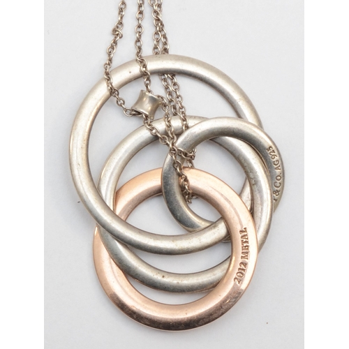 180 - Tiffany & Co, a silver and gold plated hooped pendant on chain, 13gm.