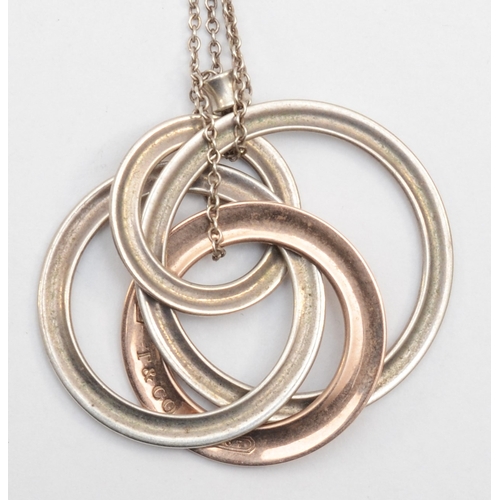 180 - Tiffany & Co, a silver and gold plated hooped pendant on chain, 13gm.