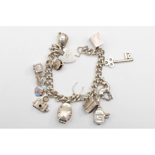 183 - A silver heart shaped clasped charm bracelet with charms, 65gm.