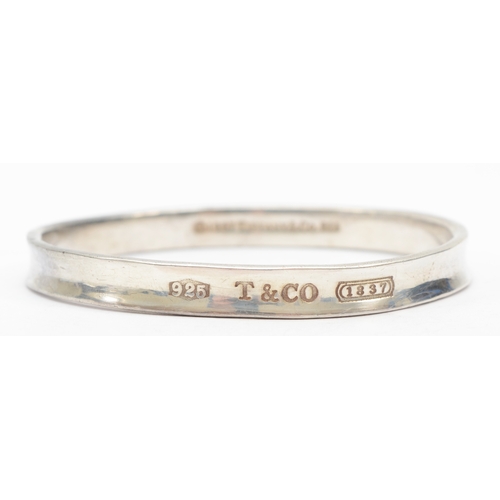 192 - Tiffany & Co, a silver concave bangle, 62 x 59mm, 34gm.