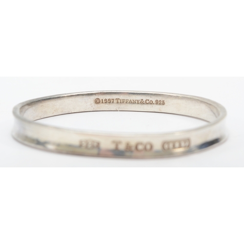 192 - Tiffany & Co, a silver concave bangle, 62 x 59mm, 34gm.