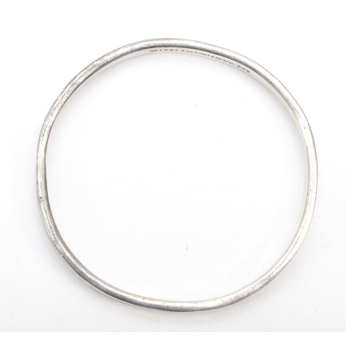 192 - Tiffany & Co, a silver concave bangle, 62 x 59mm, 34gm.