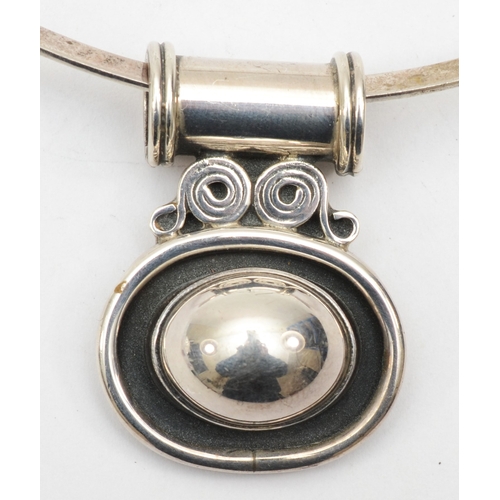 193 - Silvarious, a silver modernist pendant 38 x 28mm, on a torque necklace, 37gm.