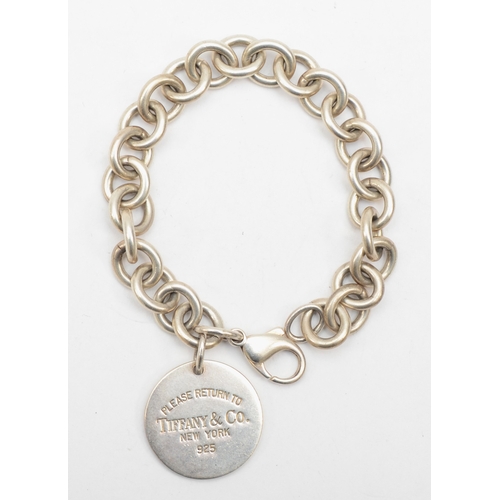 195 - Tiffany & Co, a silver identity bracelet with round tag, 18cm, 36gm.