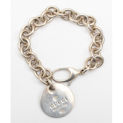 196 - Gucci, a silver identity bracelet with round tag, 19cm, 32gm.