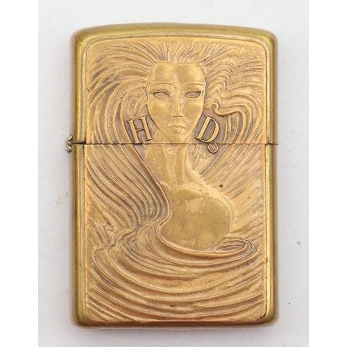 132 - Zippo, a brass petrol lighter with a long haired lady and H D.