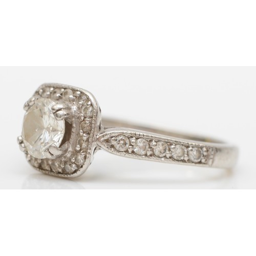 207 - A platinum and diamond cluster ring, claw set with a brilliant cut stone, calculated to weigh 0.50ct... 