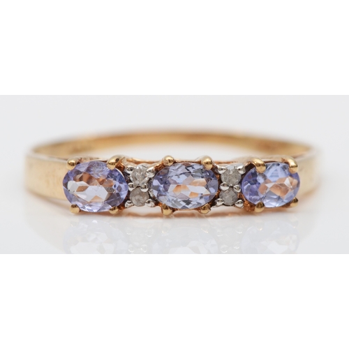 212 - A 10k gold tanzanite and eight cut diamond cluster ring, N-O, 1.3gm.