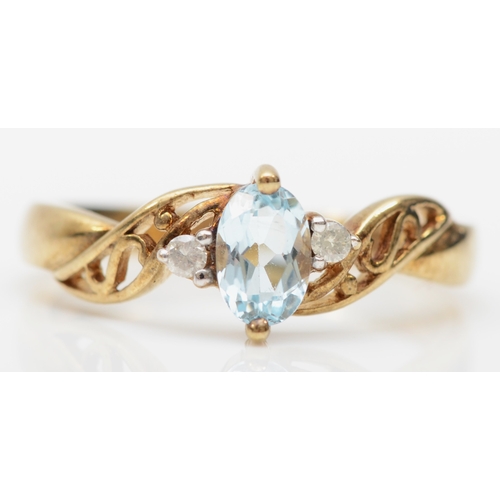 214 - A 9ct gold aquamarine dress ring, flanked by two brilliant cut diamonds, N, 2gm.