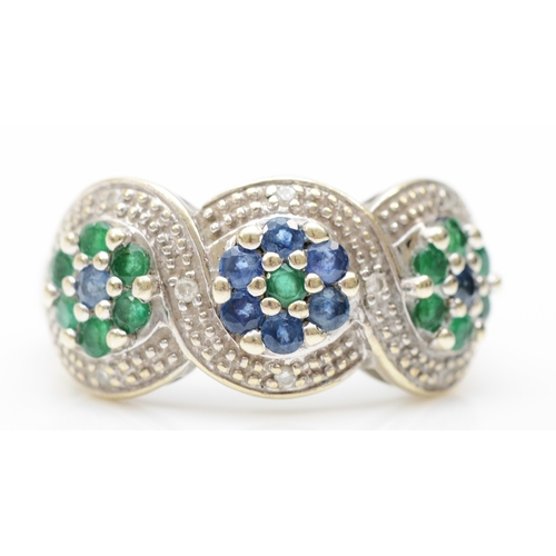 215 - A 9ct white gold emerald, sapphire and brilliant cut diamond cluster ring, N-O, 3.8gm.