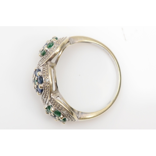 215 - A 9ct white gold emerald, sapphire and brilliant cut diamond cluster ring, N-O, 3.8gm.