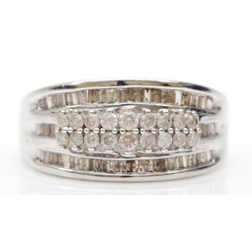 223 - A 10k white gold diamond cluster ring, set with brilliant and baguette cut stones, M, 3.9gm.