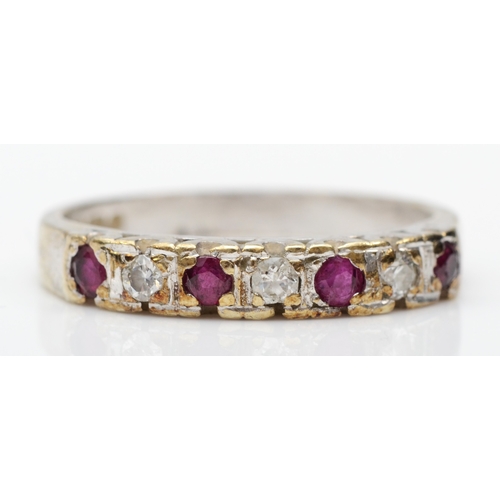 224 - A 9ct gold ruby and brilliant cut diamond dress ring, N-O, 2.8gm.