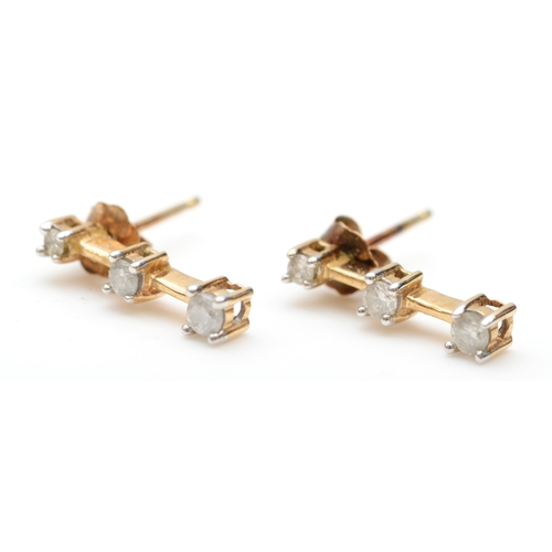 247 - A pair of 9k gold graduating three stone diamond drop stud earrings, 13mm, 1gm.