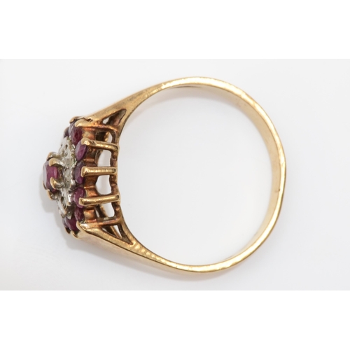 251 - A 9ct gold ruby and diamond cluster ring, P-Q, 3.8gm.