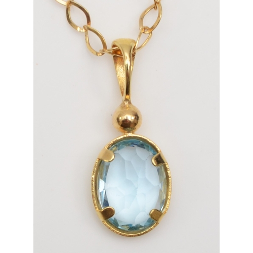 258 - An unmarked gold blue topaz pendant on 9k chain, with matching ear studs, 2.3gm.