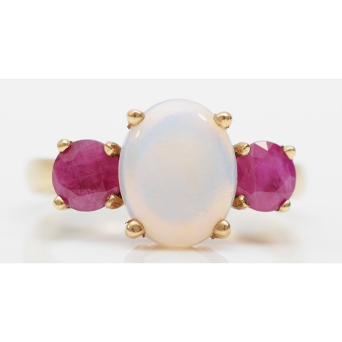 265 - A 9ct gold three stone opal and synthetic ruby dress ring, O, 3.6gm.