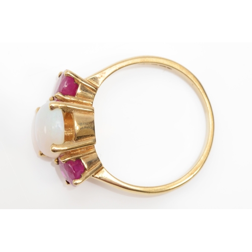 265 - A 9ct gold three stone opal and synthetic ruby dress ring, O, 3.6gm.