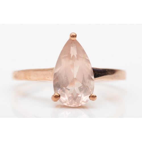 269 - A 9ct rose gold pear cut morganite dress ring, O, 2.4gm.