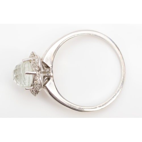 275 - A 9ct white gold quartz and diamond floral dress ring, T, 2.8gm.