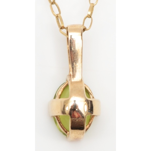 277 - An unmarked gold peridot and diamond pendant on chain, 16 x 7mm, 2gm.