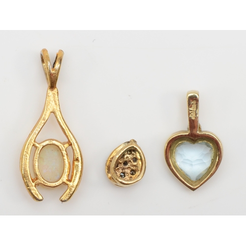 281 - A 9ct gold topaz and diamond heart shaped pendant, 14 x 8mm, together with two unmarked gold opal an... 