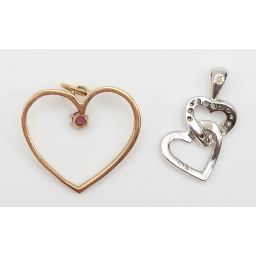 282 - A 9ct white gold diamond heart shaped pendant, 20 x 10mm, with a 9ct gold ruby heart shaped pendant,... 