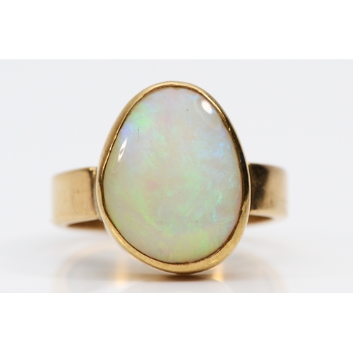 285 - A 9ct gold free form opal dress ring, flashes of green, orange, blue, L, 3.9gm.