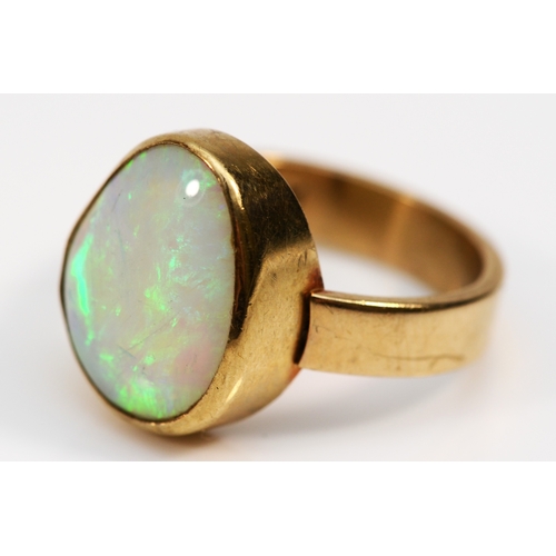 285 - A 9ct gold free form opal dress ring, flashes of green, orange, blue, L, 3.9gm.