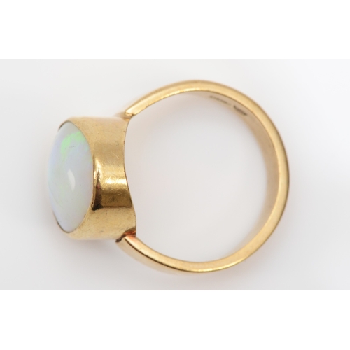 285 - A 9ct gold free form opal dress ring, flashes of green, orange, blue, L, 3.9gm.