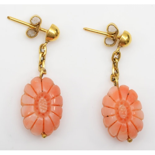 291 - A pair of unmarked gold carved floral coral drop earrings, 33mm, 5.1gm.