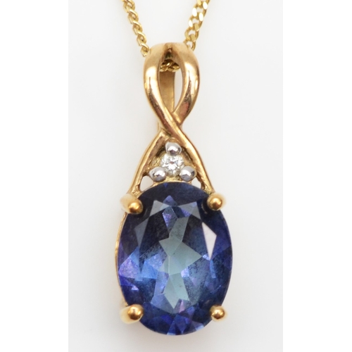 294 - An unmarked gold coated topaz and diamond pendant on chain, 15 x 6mm,  1.7gm.