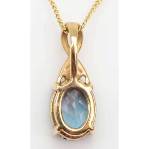 294 - An unmarked gold coated topaz and diamond pendant on chain, 15 x 6mm,  1.7gm.