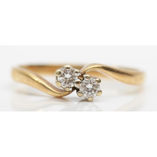 296 - A 9ct gold two stone brilliant cut diamond ring, O, 1.7gm.