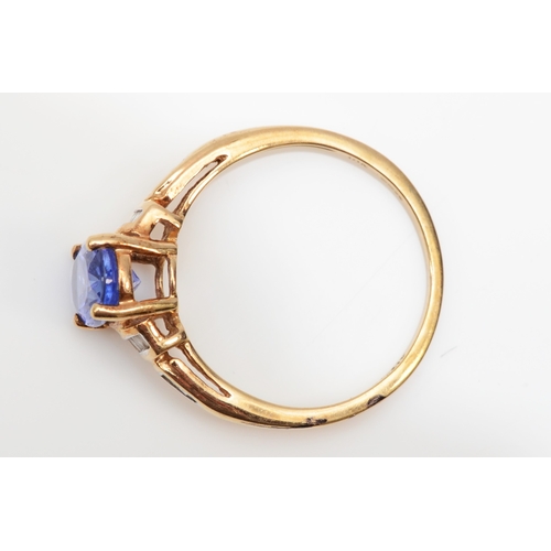 298 - A 9ct gold tanzanite and diamond dress ring, O, 2.1gm.