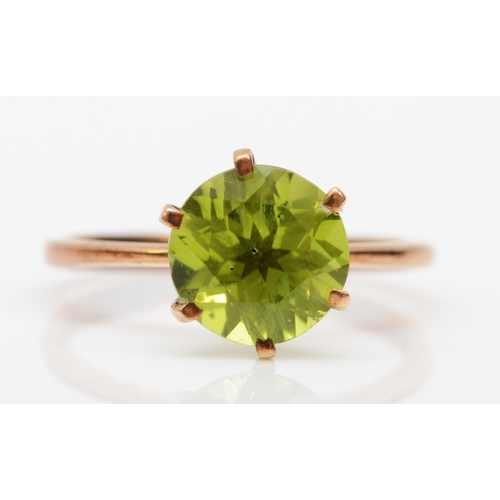 300 - A 9ct gold peridot dress ring, O, 1.8gm.