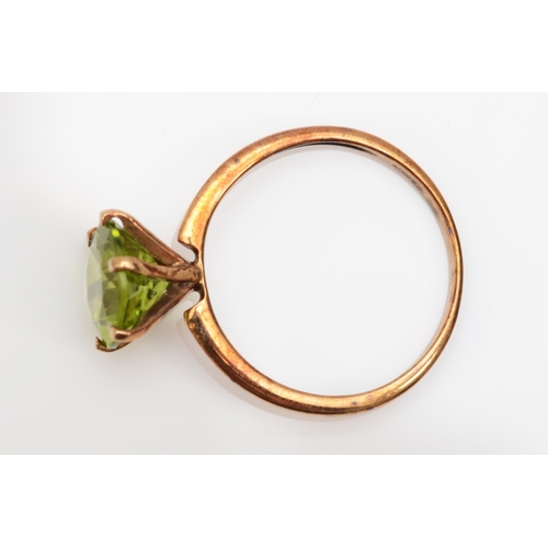 300 - A 9ct gold peridot dress ring, O, 1.8gm.