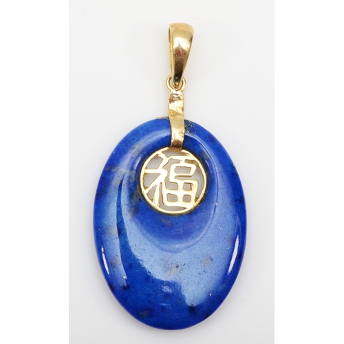 304 - A 14k gold lapis lazuli oval pendant with Chinese character decoration, 35 x 18mm, 2.7gm.