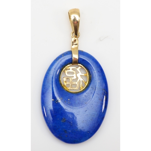 304 - A 14k gold lapis lazuli oval pendant with Chinese character decoration, 35 x 18mm, 2.7gm.