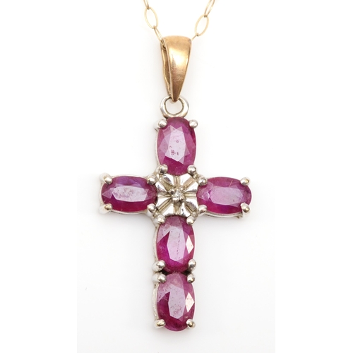 309 - A 9ct gold ruby cross pendant on chain, 25 x 16mm, 2.9gm.