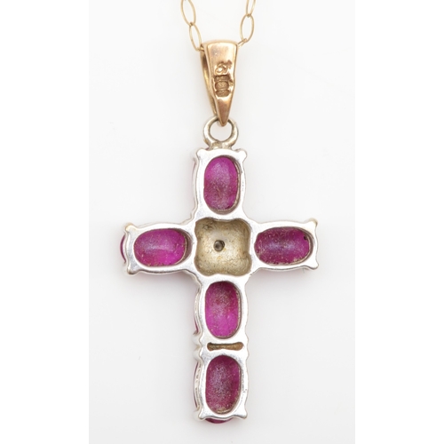 309 - A 9ct gold ruby cross pendant on chain, 25 x 16mm, 2.9gm.